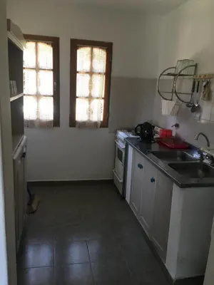 a small kitchen with a sink and a stove at Residencial del Golf in Alta Gracia