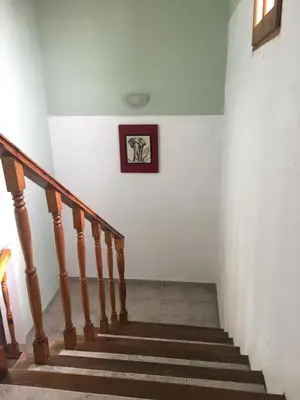 a stairway with a picture hanging on the wall at Residencial del Golf in Alta Gracia