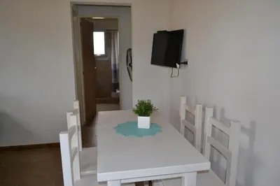 a white table and chairs with a potted plant on it at Cabañas Los Álamos Panaholma in Panaholma