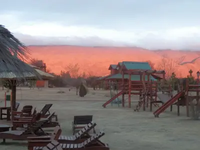 a group of chairs and a playground in the desert at Las Cortaderas Cabañas de Tronco in Nono