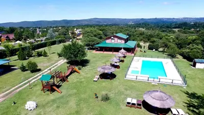 an aerial view of a resort with a swimming pool at Las Cortaderas Cabañas de Tronco in Nono