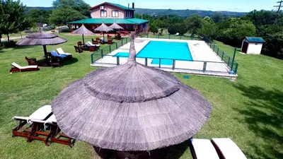 an overhead view of a pool with an umbrella at Las Cortaderas Cabañas de Tronco in Nono
