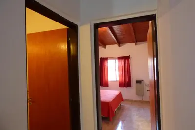 a room with a bedroom with a bed and a mirror at Departamento Centrico Laprida in Cordoba