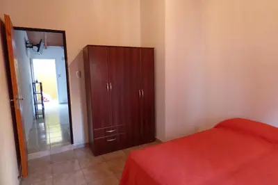 a bedroom with a wooden cabinet and a door to a hallway at Departamento Centrico Laprida in Cordoba