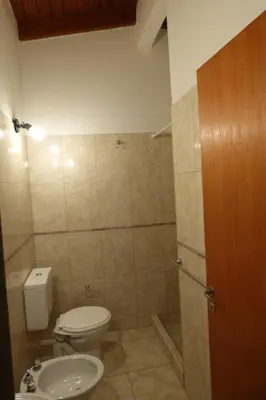 a small bathroom with a toilet and a shower at Departamento Centrico Laprida in Cordoba