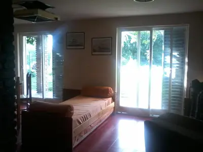 a bedroom with a bed and two large windows at Aires de San Antonio in San Antonio de Arredondo