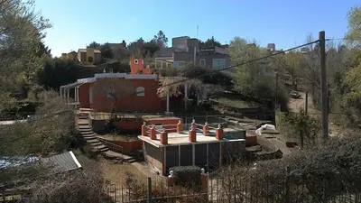 a train yard with a building on a hill at Aires de San Antonio in San Antonio de Arredondo