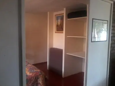a room with a bed and a closet with shelves at Aires de San Antonio in San Antonio de Arredondo