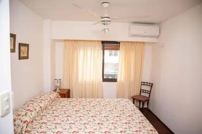 a bedroom with a bed and a ceiling fan at 3 o 4 PERSONAS A 150 Mts SANATORIO ALLENDE in Cordoba
