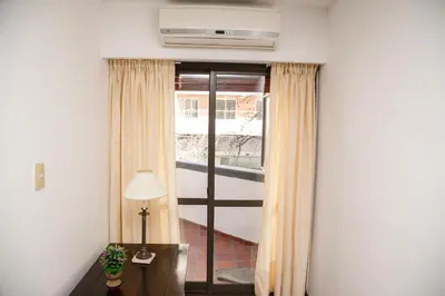 a room with a window with curtains and a lamp at 3 o 4 PERSONAS A 150 Mts SANATORIO ALLENDE in Cordoba