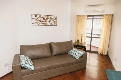 a living room with a brown couch in a room at 3 o 4 PERSONAS A 150 Mts SANATORIO ALLENDE in Cordoba
