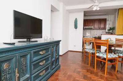 a living room with a television on top of a dresser at 3 o 4 PERSONAS A 150 Mts SANATORIO ALLENDE in Cordoba