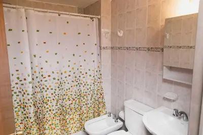 a bathroom with a shower and a toilet and a sink at 3 o 4 PERSONAS A 150 Mts SANATORIO ALLENDE in Cordoba