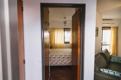 a door leading into a living room with a couch at 3 o 4 PERSONAS A 150 Mts SANATORIO ALLENDE in Cordoba