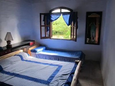 two beds in a room with a window at Luna Azul in Nono