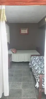 a small bedroom with a bed and a window at Inti Mayu in Villa Cura Brochero