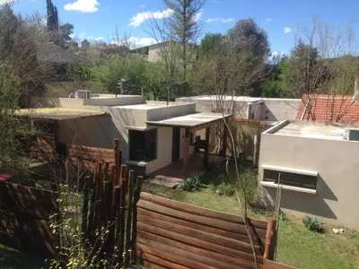 a house with a wooden fence in a yard at San Antonio Querido in Villa Carlos Paz