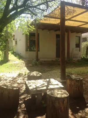 a picnic table in front of a house at San Antonio Querido in Villa Carlos Paz