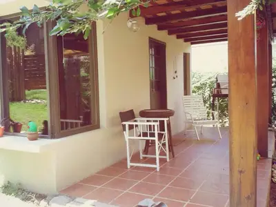a patio with a table and chairs on a house at San Antonio Querido in Villa Carlos Paz