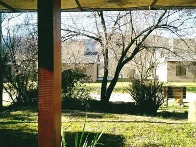 a view of a yard with a dog in the distance at San Antonio Querido in Villa Carlos Paz