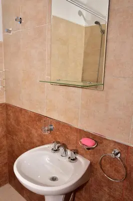a bathroom with a sink and a mirror at Departamento Pircas in Tanti