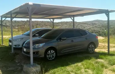 a car parked under a cover on a field at Departamento Pircas in Tanti