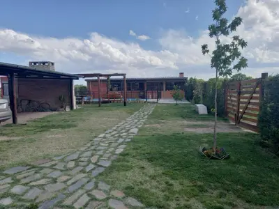 a garden with a tree and a stone path at Cabañas DAYMA in Trapiche