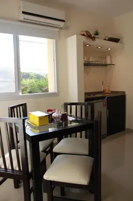 a kitchen with a table and chairs and a kitchen with a window at Villa Cabrera Apart and Suites in Cordoba