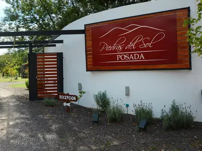 a sign on the side of a building at Posada Piedras Del Sol in Villa General Belgrano