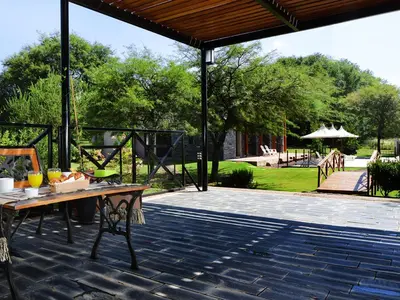 a patio with a table and a pavilion at Posada Piedras Del Sol in Villa General Belgrano