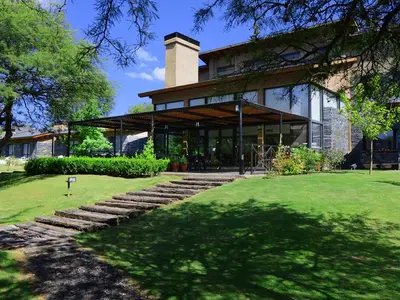 a house with stairs leading up to it at Posada Piedras Del Sol in Villa General Belgrano