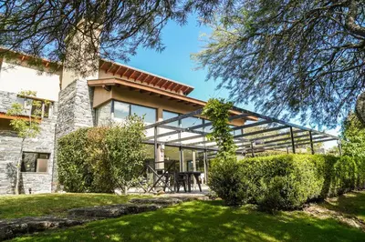an exterior view of a house with a patio at Posada Piedras Del Sol in Villa General Belgrano