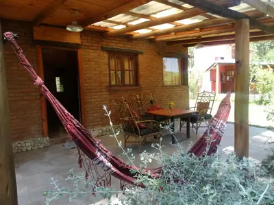 a porch with a hammock on a patio at Cabañas 