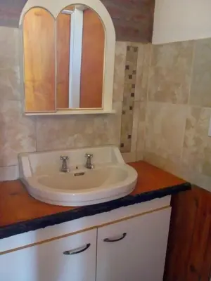a bathroom with a sink and a mirror on a counter at Cabañas 