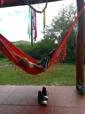 a man is sleeping in a hammock at Mainame Traslasierra in Los Hornillos