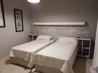 two beds sitting next to each other in a bedroom at Colores Rio Cuarto in Río Cuarto