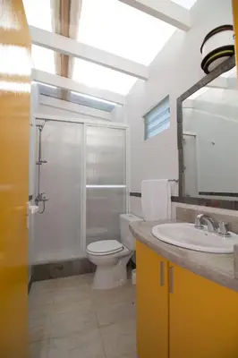 a bathroom with a toilet and a sink and a mirror at Colores Rio Cuarto in Río Cuarto