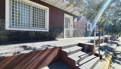 a house with stairs in front of a building at Colores Rio Cuarto in Río Cuarto