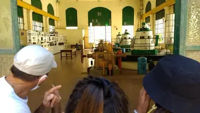 two people standing in a factory looking at a machine at Lo de Lily in Embalse