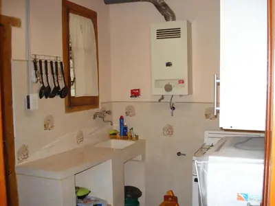 a kitchen with a sink and a mirror at Lo de Lily in Embalse