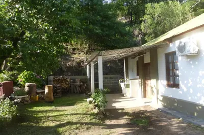 a small white house with a yard next to it at Lo de Lily in Embalse