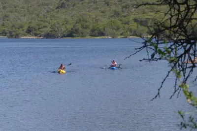 two people are kayaking in a large lake at Lo de Lily in Embalse