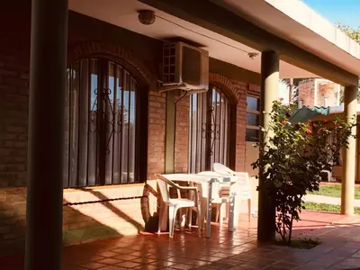 a patio with a table and chairs on a building at Aoniken Cabañas in Villa Cura Brochero