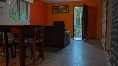 a living room with a couch and a table at Hostel El Refugio de Las Aves in Santa Rosa de Calamuchita