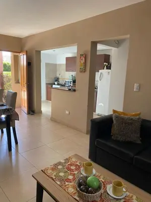 a living room with a couch and a table at Departamento duplex Champaqui in Villa General Belgrano
