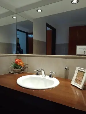 a sink in a bathroom with a mirror at Departamento duplex Champaqui in Villa General Belgrano