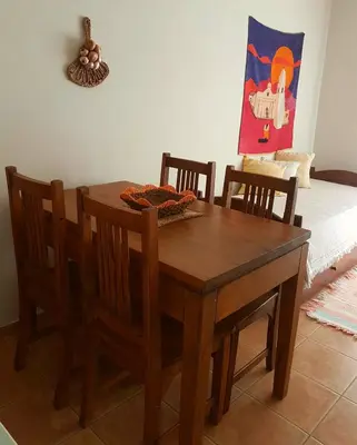 a wooden dining room table and chairs in a room at Vistas Apart in Embalse