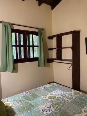 a bedroom with a bed and a window at Cabañas el Gauchito in Los Reartes