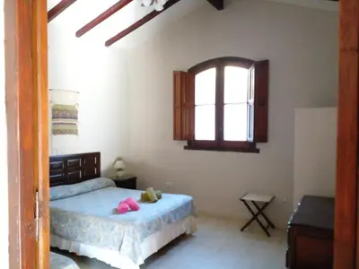 a bedroom with a bed and a window at El Solar in La Bolsa