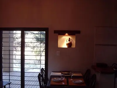 a dining room with a table and chairs and a window at El Solar in La Bolsa